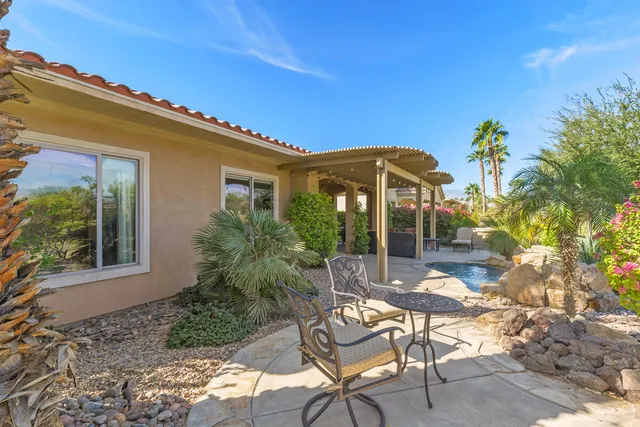 a view of a street with a building and palm trees