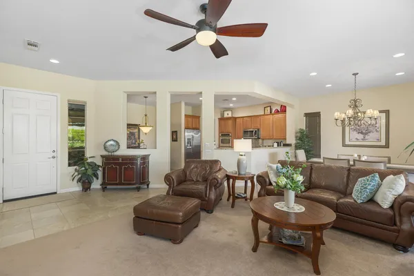 a view of a dining room with furniture wooden floor and chandelier
