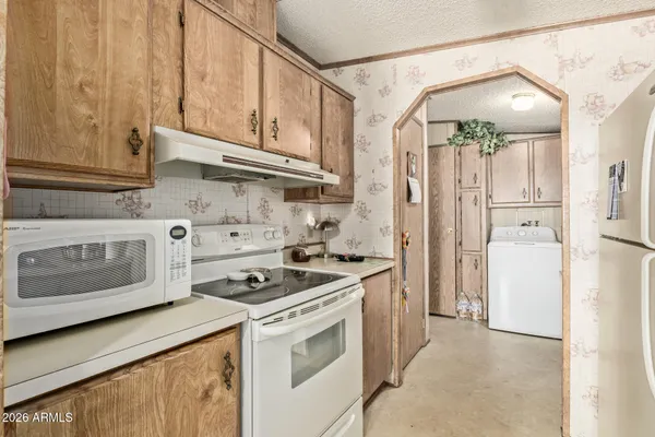 a kitchen with stainless steel appliances granite countertop a stove a refrigerator and a white cabinets