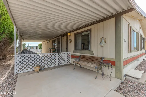 a view of a patio with table and chairs with wooden floor and fence
