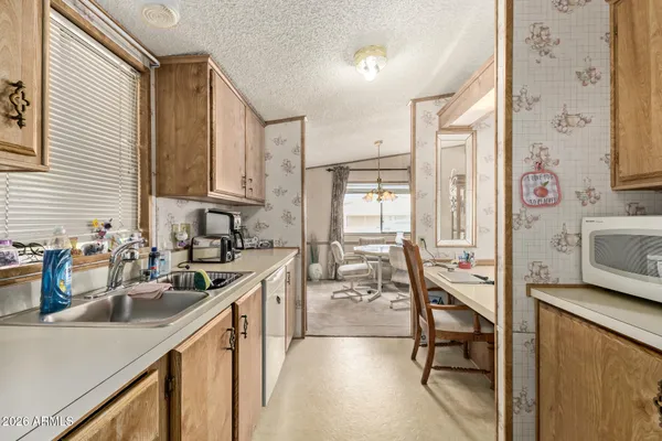 a kitchen with granite countertop sink cabinets and outdoor view