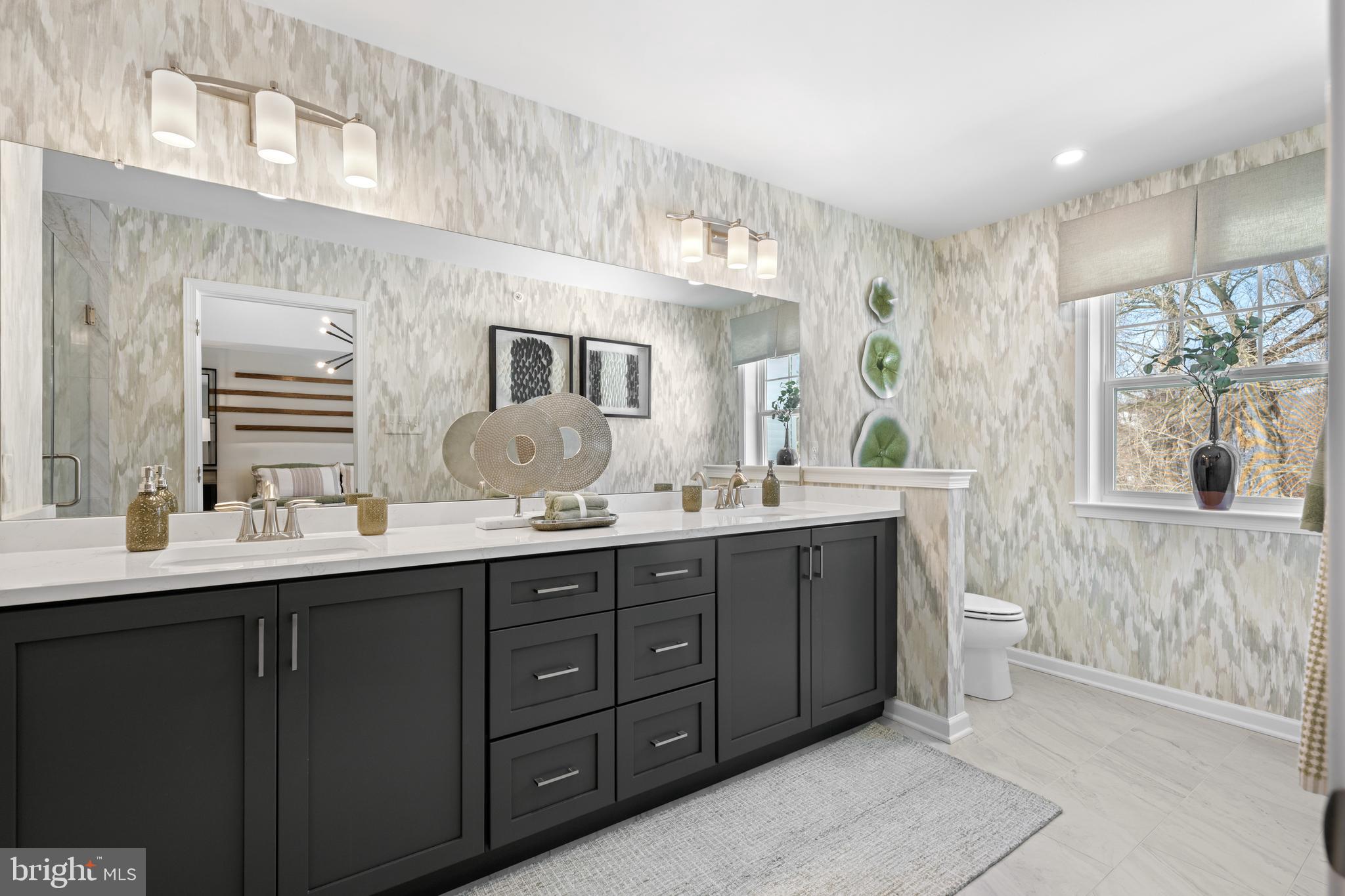 150 Foragers Lane Kennett Square, PA 19348 - Photo 21 of 33 a spacious bathroom with a double vanity sink a large mirror and a toilet