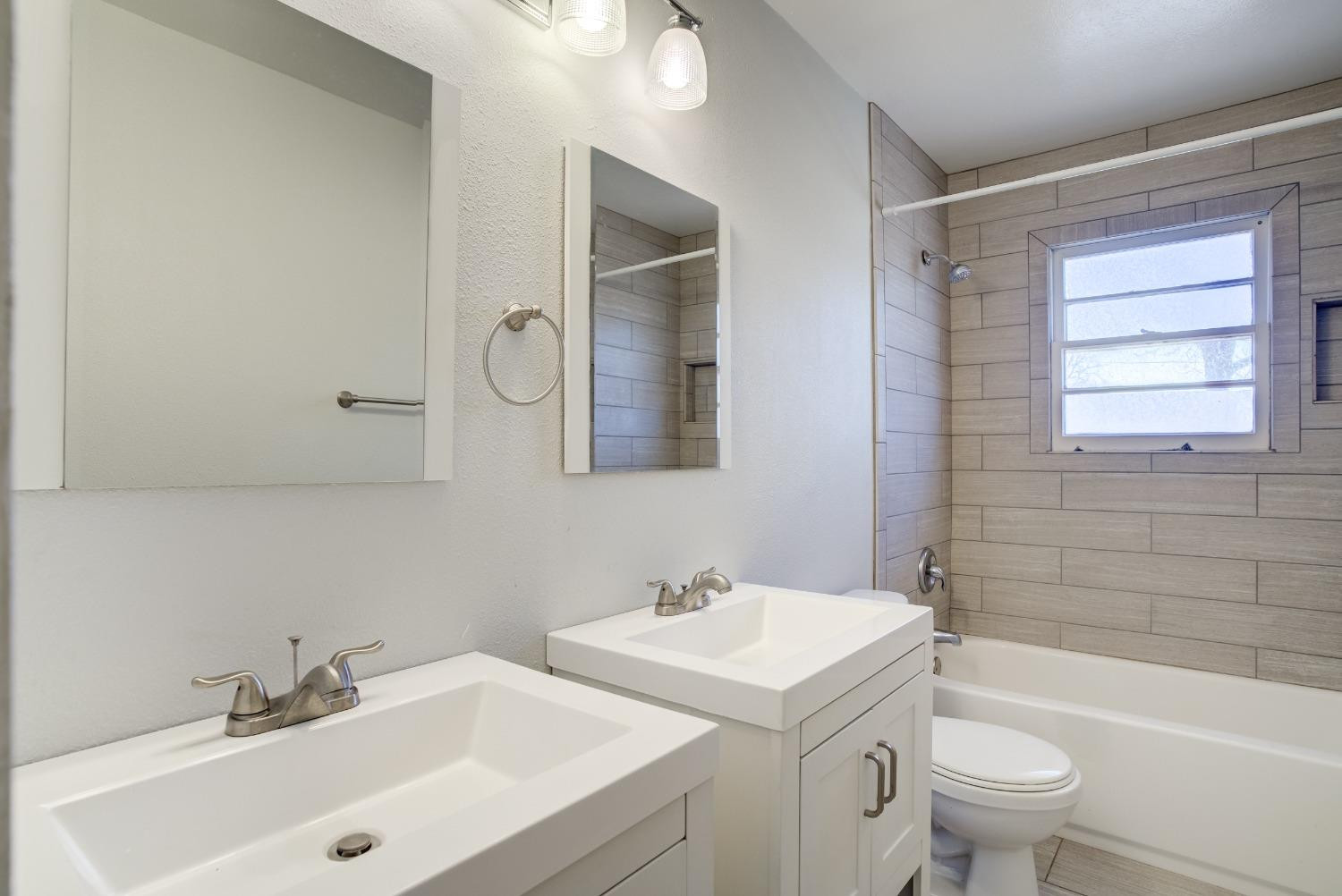 3011 44th Street Lubbock, TX 79413 - Photo 11 of 19 a bathroom with a sink a toilet and shower