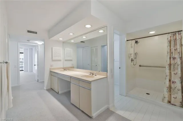 a bathroom with a tub sink shower and mirror