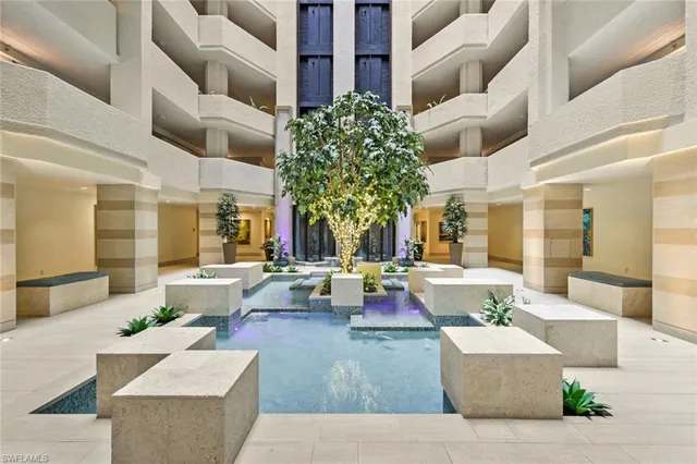 a living room with fireplace furniture and a large window