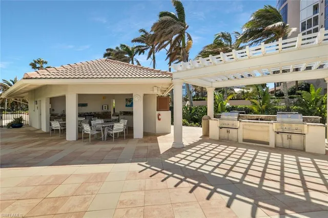 a view of a patio with table and chairs