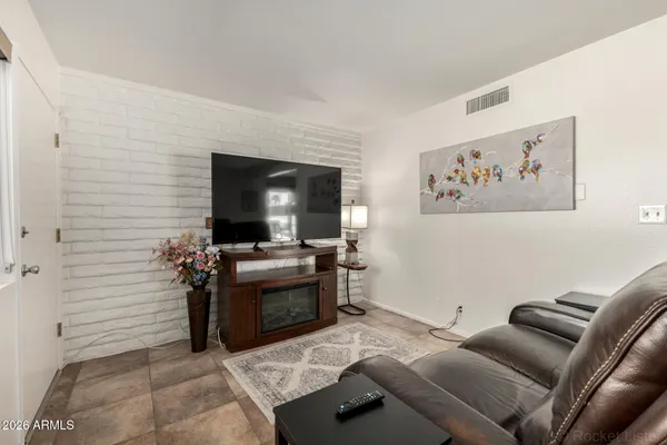 a view of a livingroom with furniture and a flat screen tv