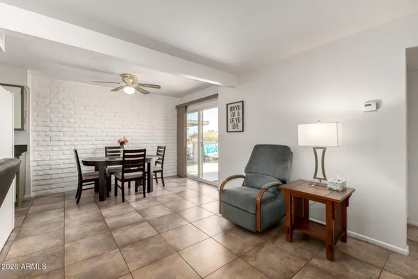a view of a dining room with furniture and a chandelier fan