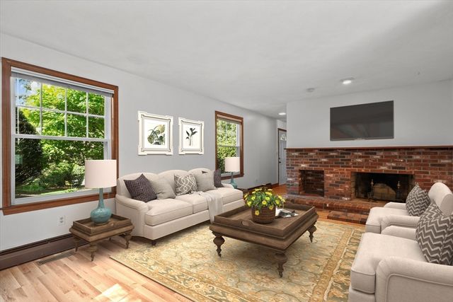 a view of a room with wooden floor and window