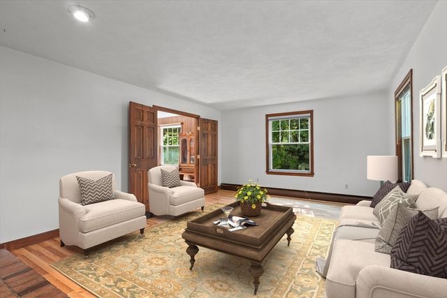 a view of a room with wooden floor and windows