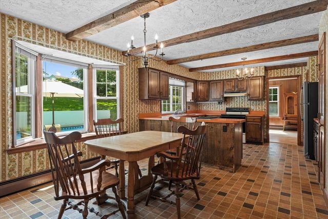 a kitchen with stainless steel appliances granite countertop a sink and a refrigerator