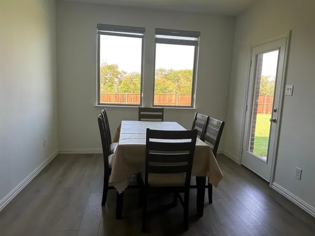 a view of kitchen with stainless steel appliances refrigerator stove microwave and kitchen island