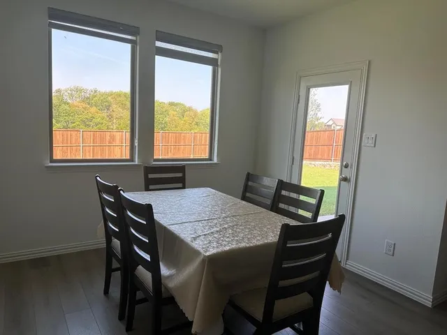 a view of a dining room with furniture and windows