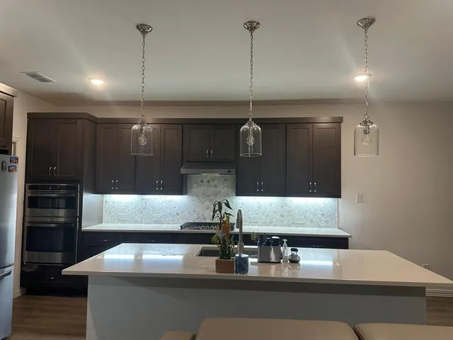 a living room with stainless steel appliances kitchen island granite countertop furniture and a fireplace