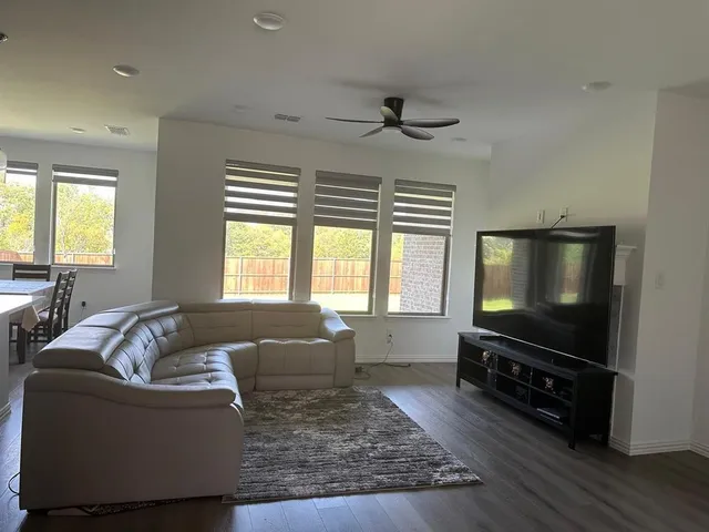 a kitchen with stainless steel appliances granite countertop a sink refrigerator and cabinets