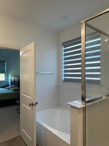 a bathroom with a bathtub and a shower
