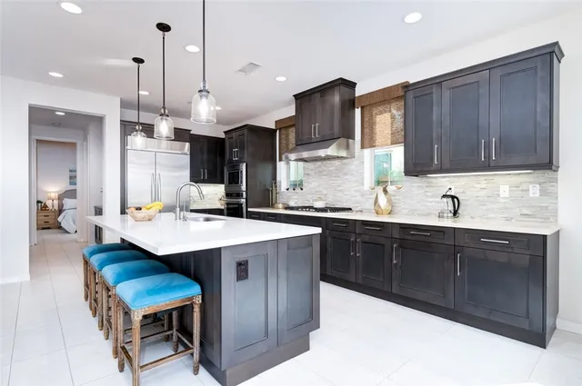 a large kitchen with a table and chairs