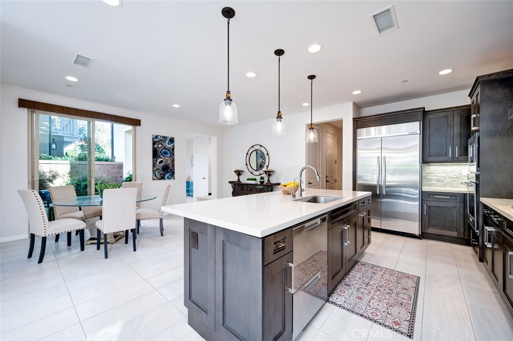 126 Brambles Irvine, CA 92618 - Photo 12 of 59 a large kitchen with a table and chairs
