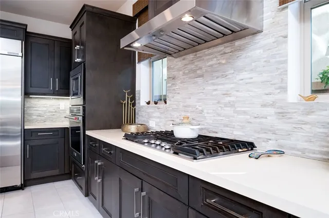 a kitchen with stainless steel appliances granite countertop a stove and a microwave