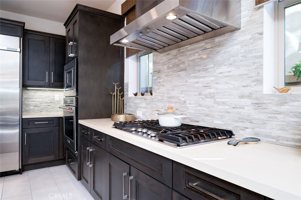 126 Brambles Irvine, CA 92618 - Photo 14 of 59 a kitchen with a stove and a refrigerator