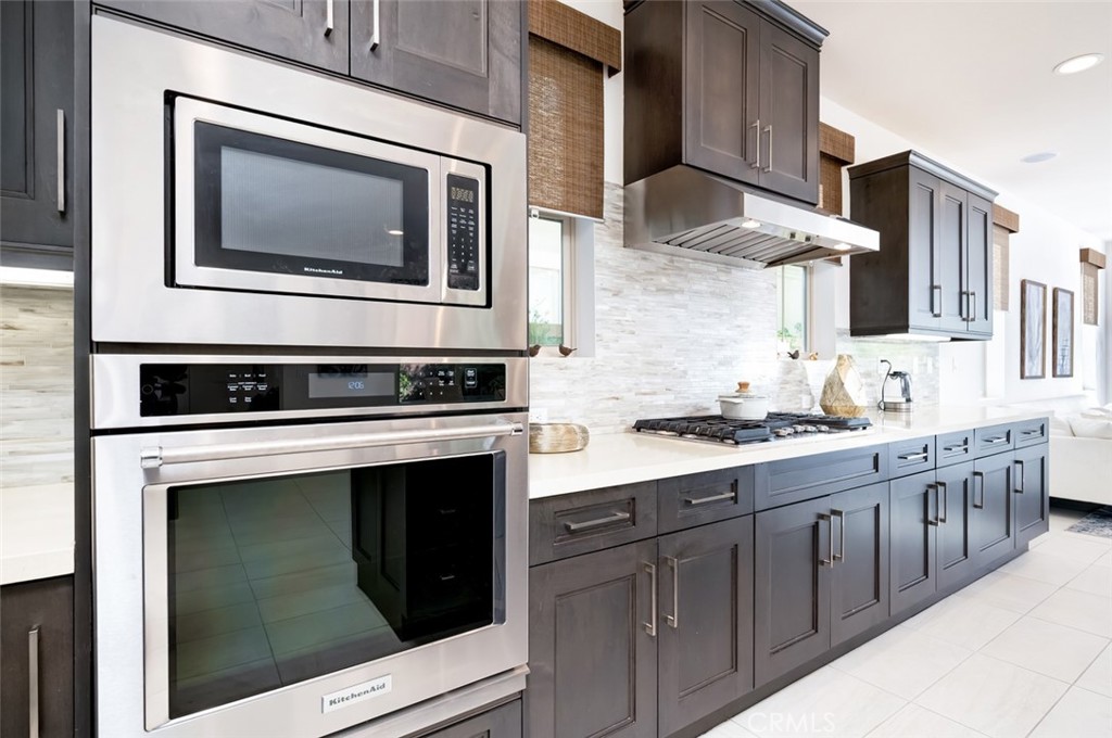 126 Brambles Irvine, CA 92618 - Photo 15 of 59 a kitchen with stainless steel appliances granite countertop a stove and a microwave