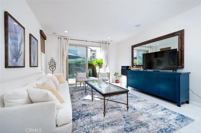 a living room with furniture and kitchen view