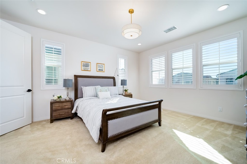 126 Brambles Irvine, CA 92618 - Photo 30 of 59 a spacious bedroom with a bed and window