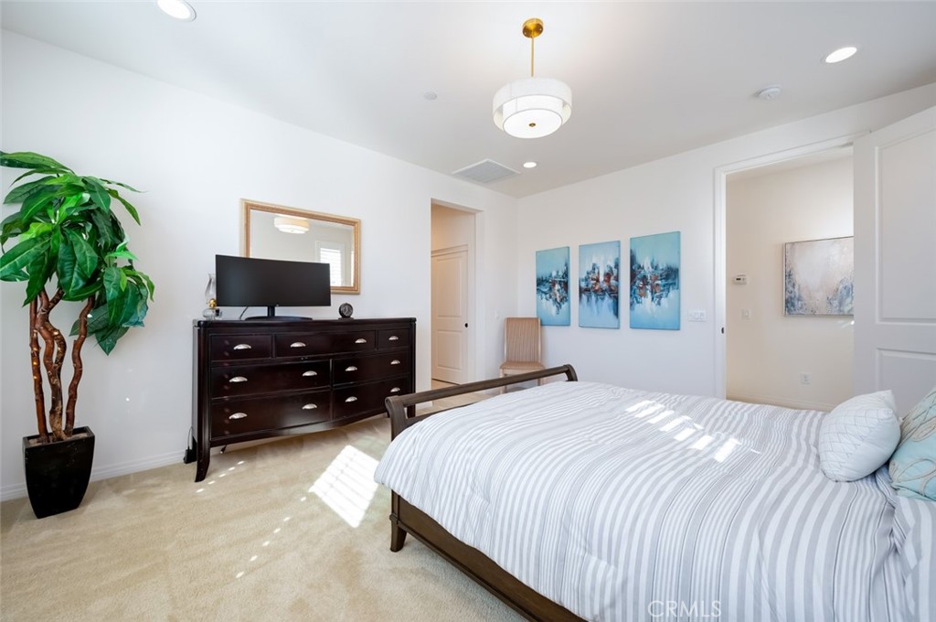 126 Brambles Irvine, CA 92618 - Photo 31 of 59 a bedroom with a bed and a potted plant
