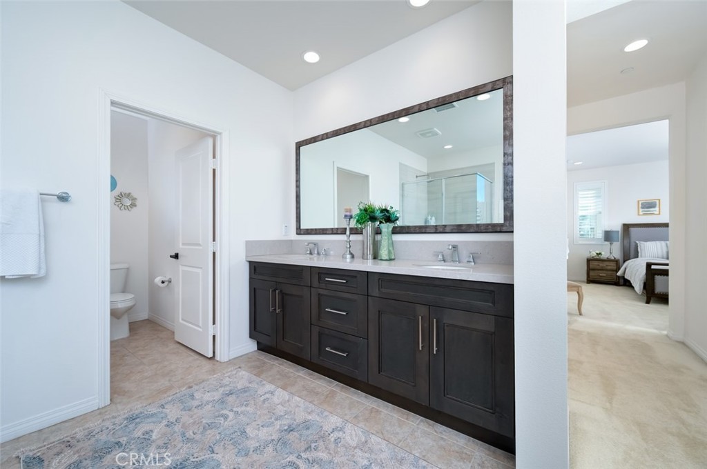 126 Brambles Irvine, CA 92618 - Photo 32 of 59 a spacious bathroom with a double vanity sink a mirror and a shower