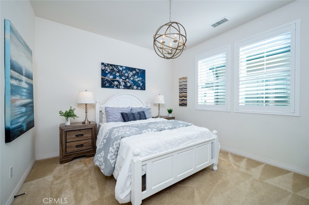 126 Brambles Irvine, CA 92618 - Photo 42 of 59 a bedroom with a large bed and a window