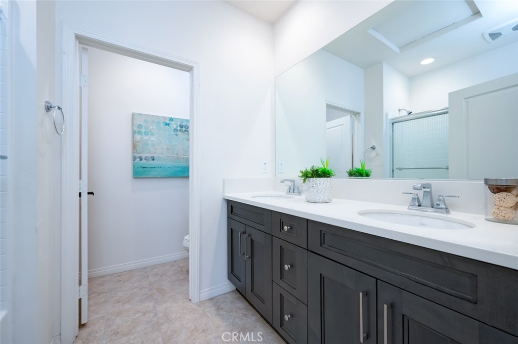 126 Brambles Irvine, CA 92618 - Photo 44 of 59 a bathroom with a double vanity sink and a mirror