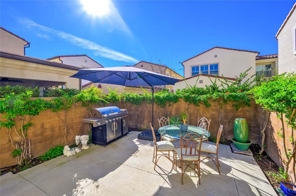 126 Brambles Irvine, CA 92618 - Photo 49 of 59 a patio with a patio table and chairs