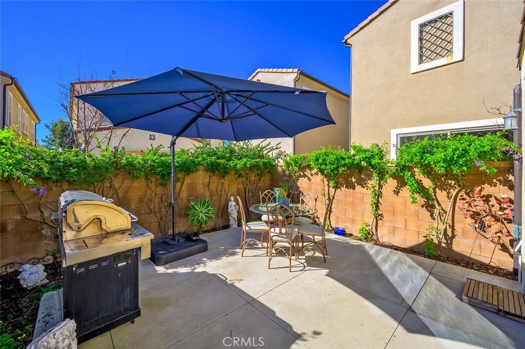 126 Brambles Irvine, CA 92618 - Photo 51 of 59 a view of a patio with couches under an umbrella