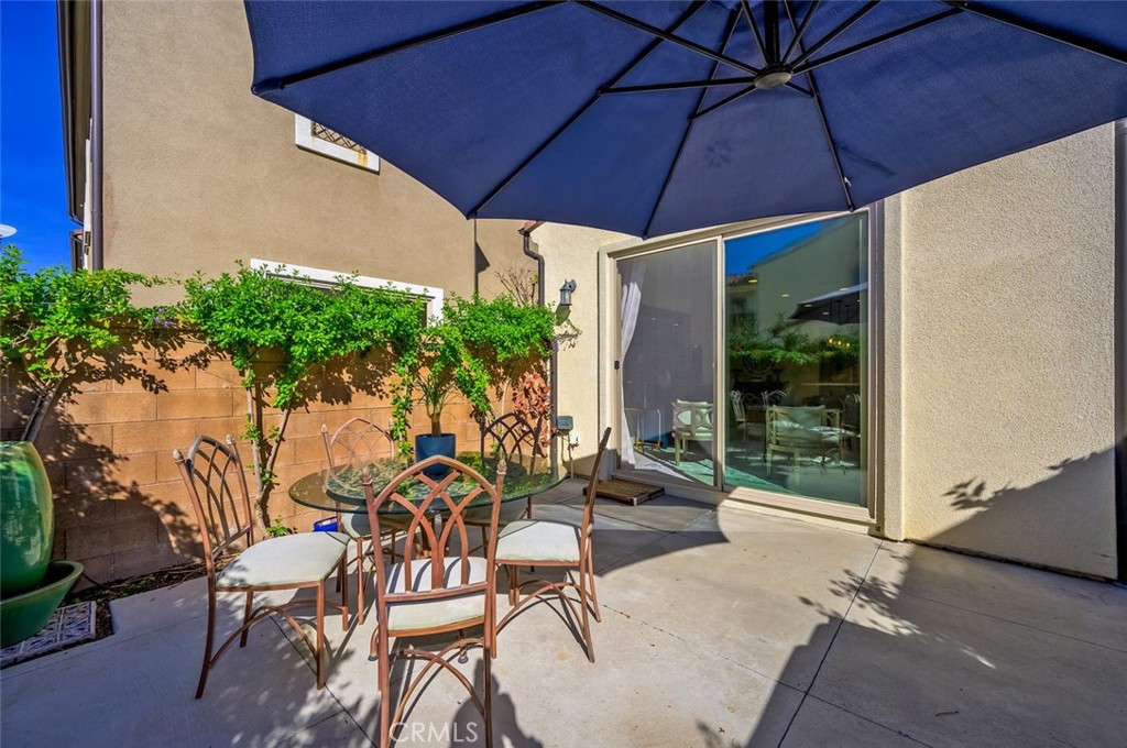 126 Brambles Irvine, CA 92618 - Photo 52 of 59 a patio with a patio table and chairs