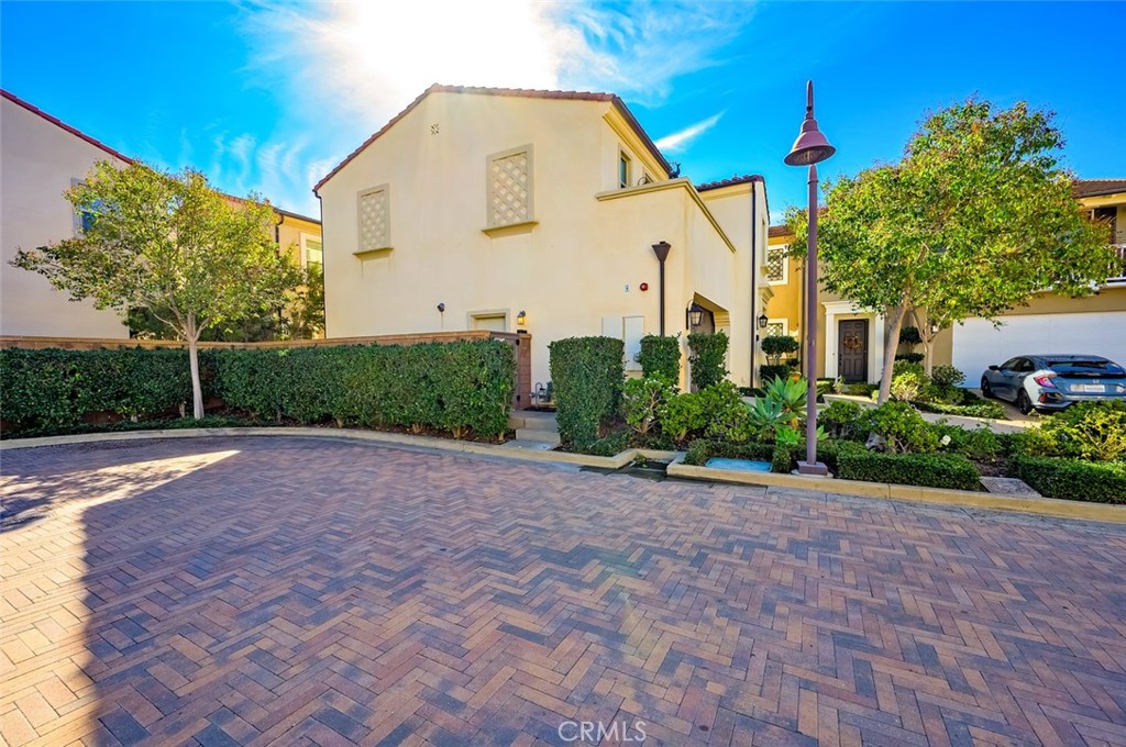 126 Brambles Irvine, CA 92618 - Photo 55 of 59 a view of a white house with a yard
