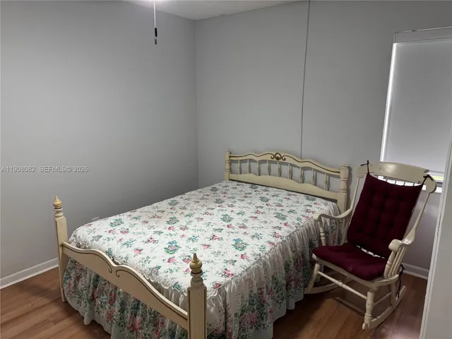 a bedroom with a bed and chair