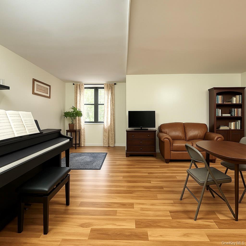 138-15 Franklin Avenue, Unit 221 Queens, NY 11355 - Photo 3 of 9 a living room with furniture and a flat screen tv