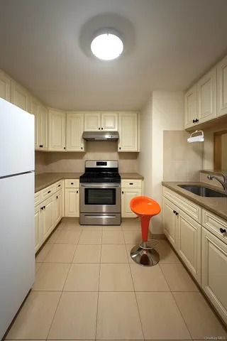 a kitchen with stainless steel appliances a stove a sink and a refrigerator
