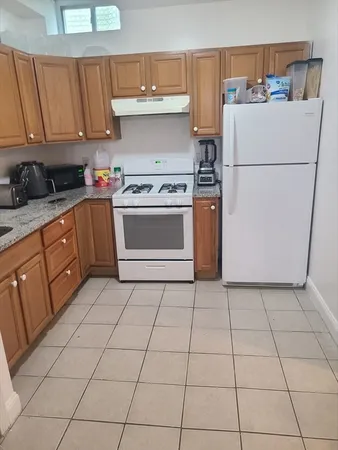 a kitchen with a cabinets and a stove top oven