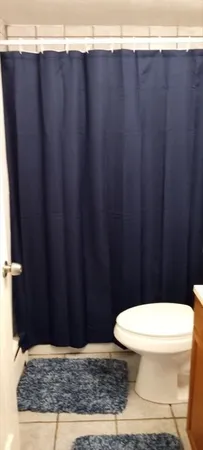 a bathroom with a toilet a sink and a window