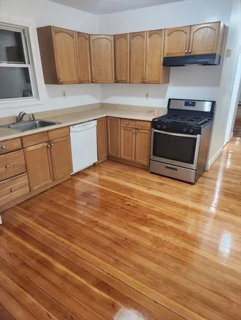 a kitchen with stainless steel appliances granite countertop a sink stove and cabinets