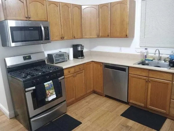 a kitchen with sink cabinets and stainless steel appliances