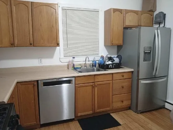 a kitchen with stainless steel appliances a refrigerator sink and cabinets