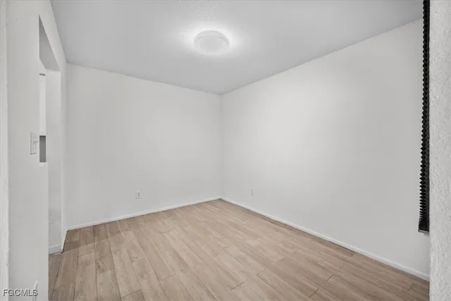 a view of room with wooden floor