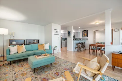 a living room with furniture and kitchen view