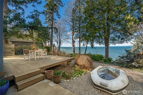 a view of backyard with swimming pool and outdoor seating