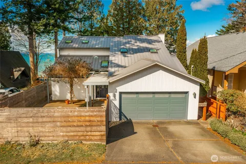 a view of a house with a yard and garage