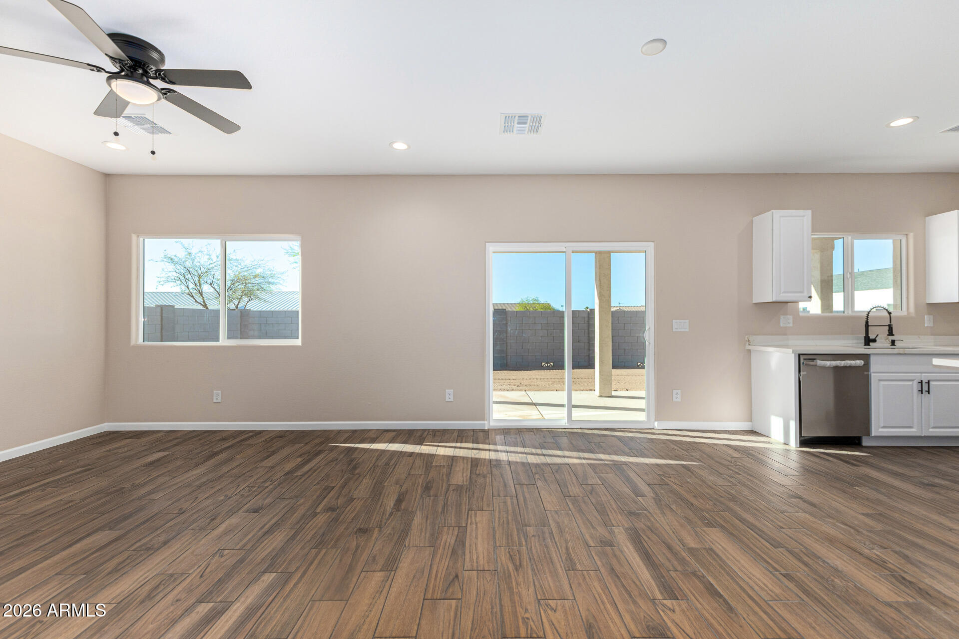 14058 South Tampico Road Arizona City, AZ 85123 - Photo 11 of 37 a view of an empty room with window and wooden floor