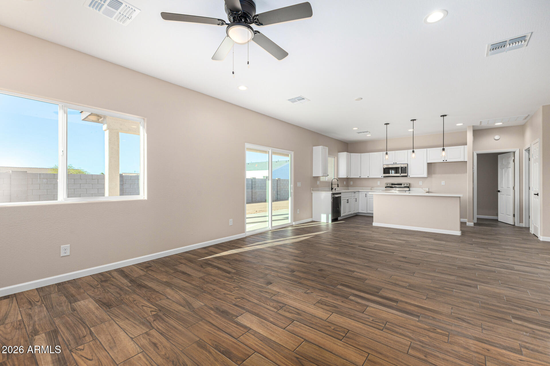 14058 South Tampico Road Arizona City, AZ 85123 - Photo 12 of 37 a view of a kitchen with a dishwasher kitchen stove cabinets and wooden floor