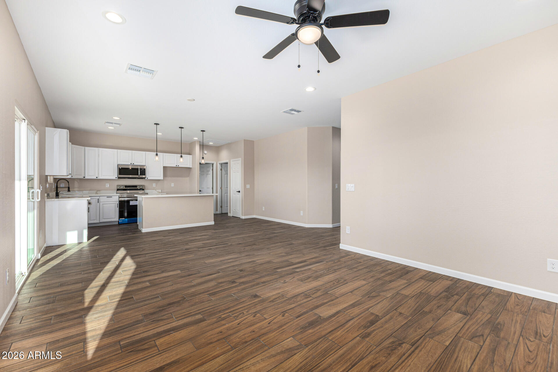 14058 South Tampico Road Arizona City, AZ 85123 - Photo 13 of 37 a view of a kitchen with a sink and stainless steel appliances